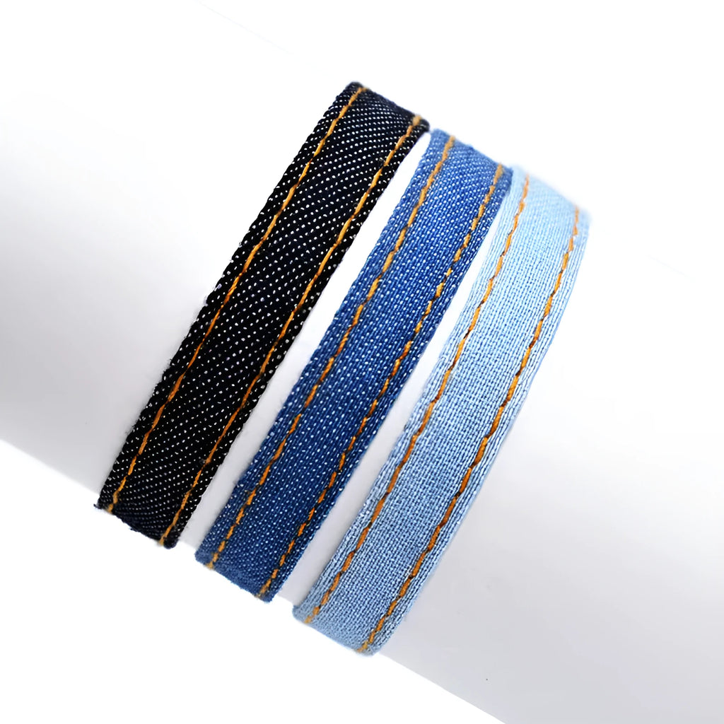 Mixed material denim-style fabric bracelet wristband for carrying travel souvenirs.