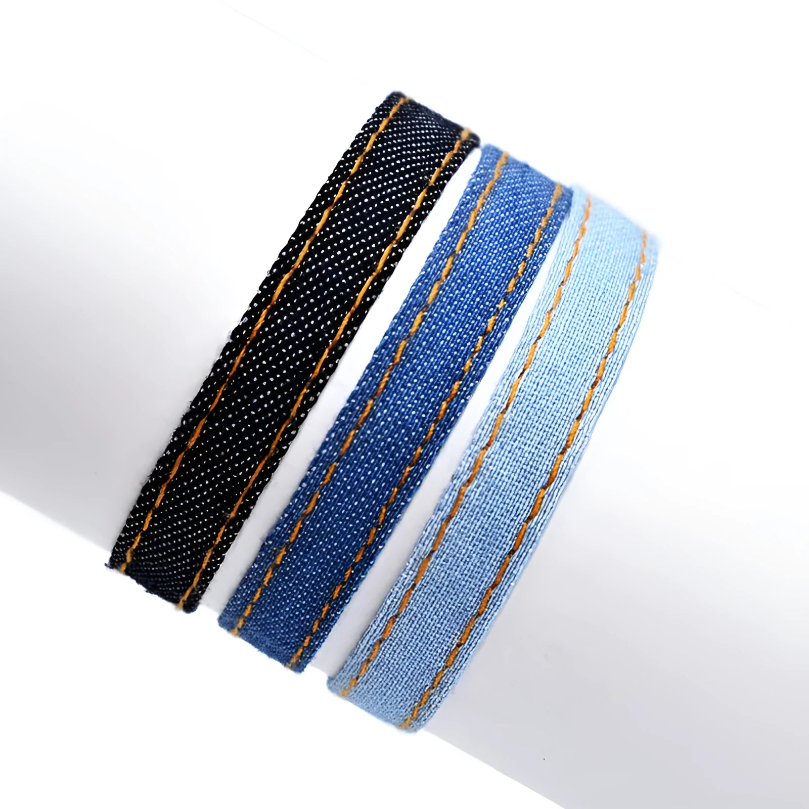Mixed material denim-style fabric bracelet wristband for carrying travel souvenirs.
