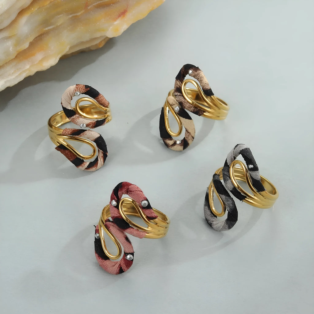 Leopard print stainless steel open mouth ring showing heart, star and geometric shapes.