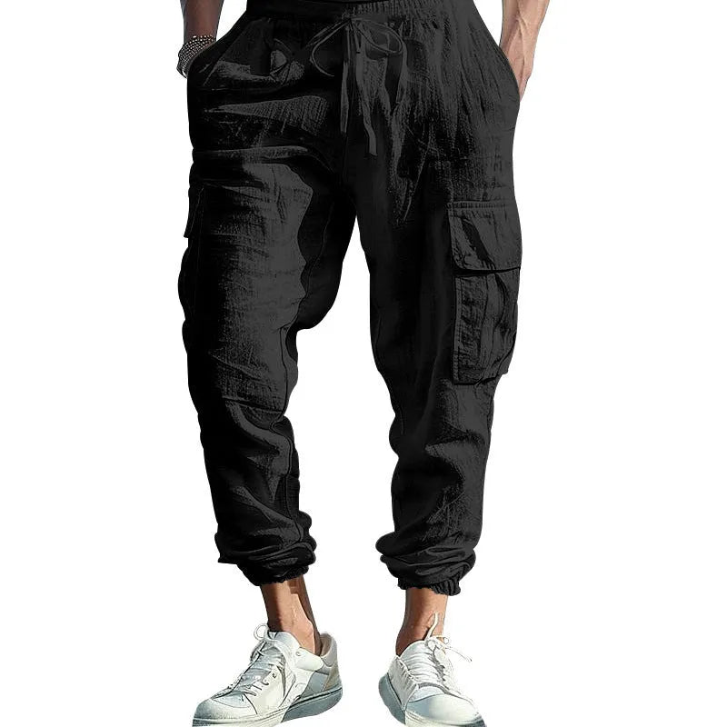 Men's loose linen trousers in Army Green with ankle ties and a multi-pocket tether detail.