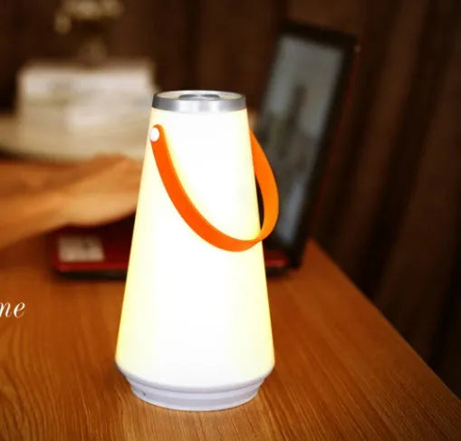White rechargeable LED night light lantern on bedside table measuring 12x12x22cm with warm light
