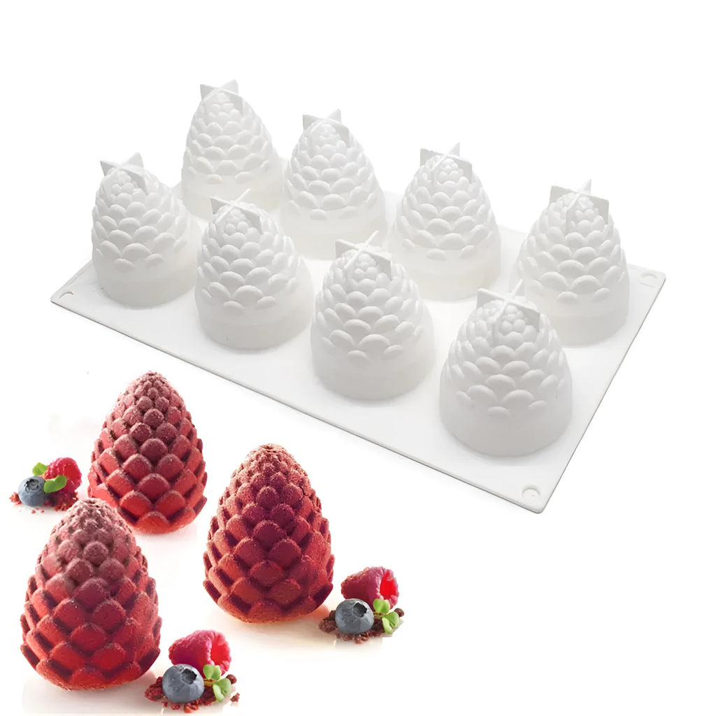 Silicone baking molds in pineapple, pear, and pine cone shapes for making mousse cakes and desserts.