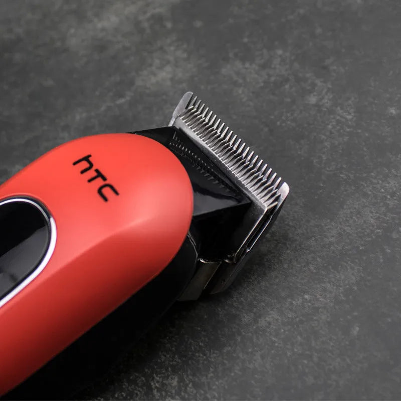 Black, red, and white digital hair clipper with brushless motor, four guide combs, charger, and cleaning tools.