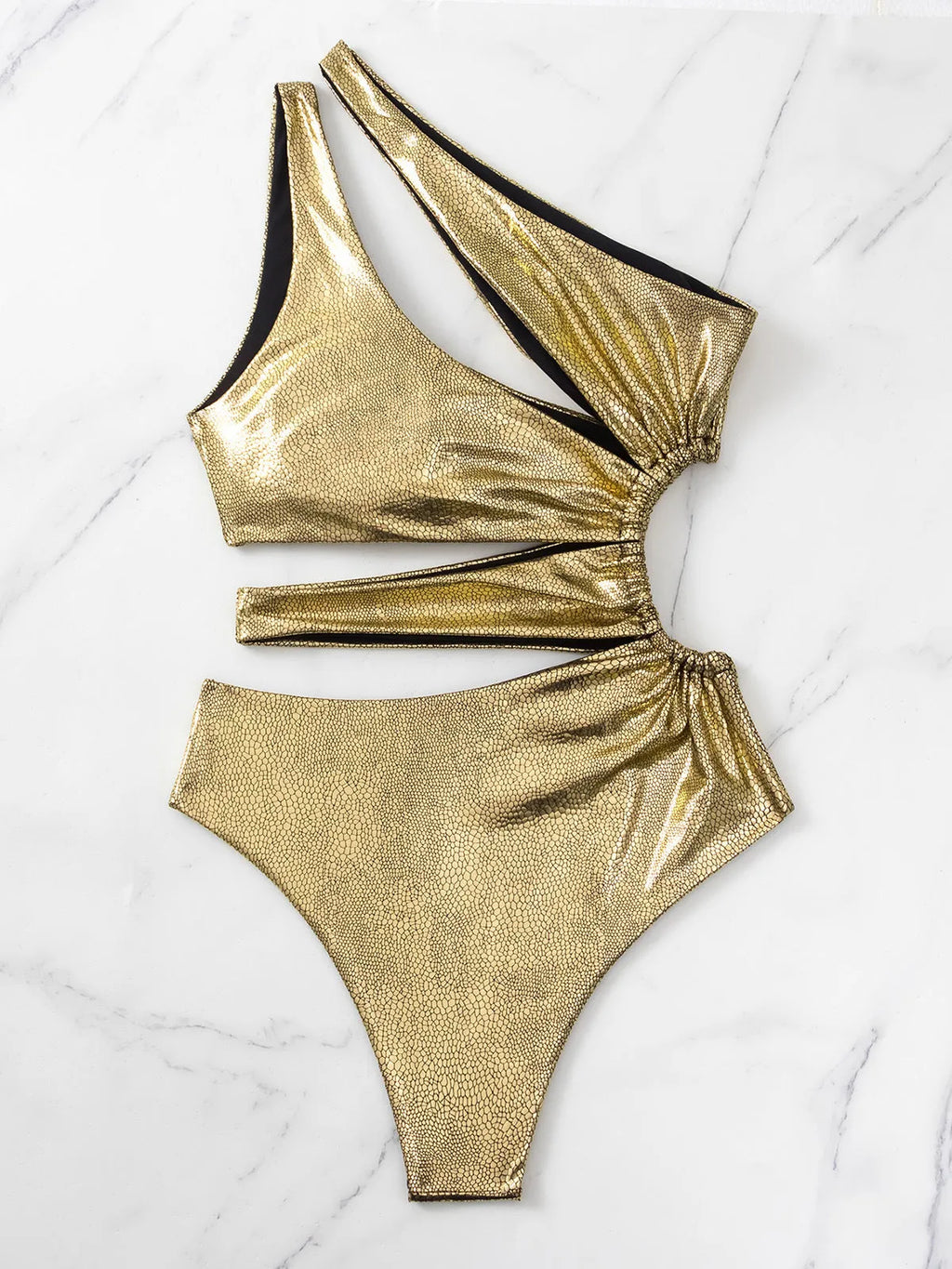 Women's gold backless one-piece swimsuit made from Spandex, shown on a mannequin.