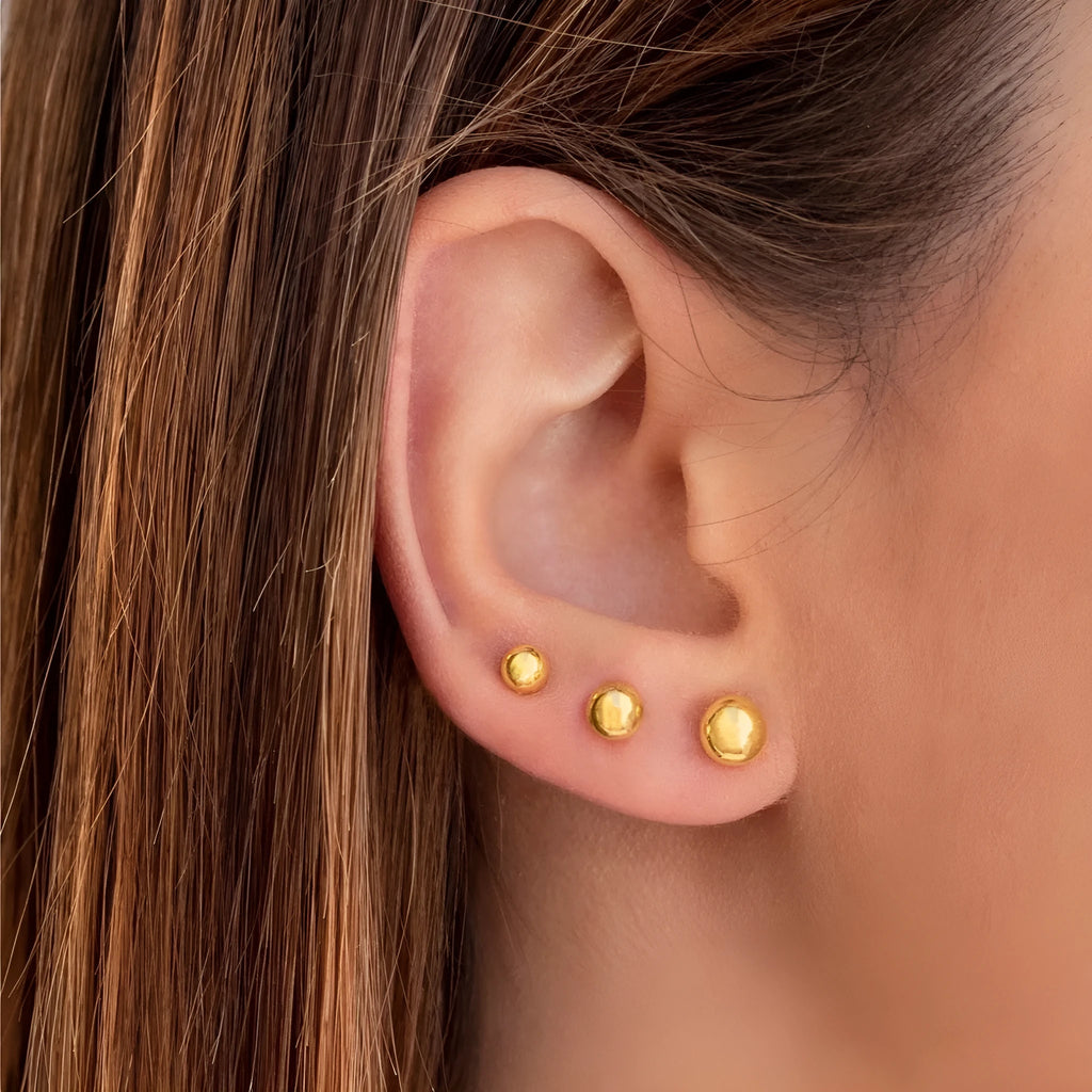 Stainless steel ball stud earrings in gold and silver finishes, showing 3mm, 4mm, 5mm and 6mm size comparison.