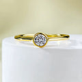 Minimalist crown-shaped silver ring with line detailing on a white background.