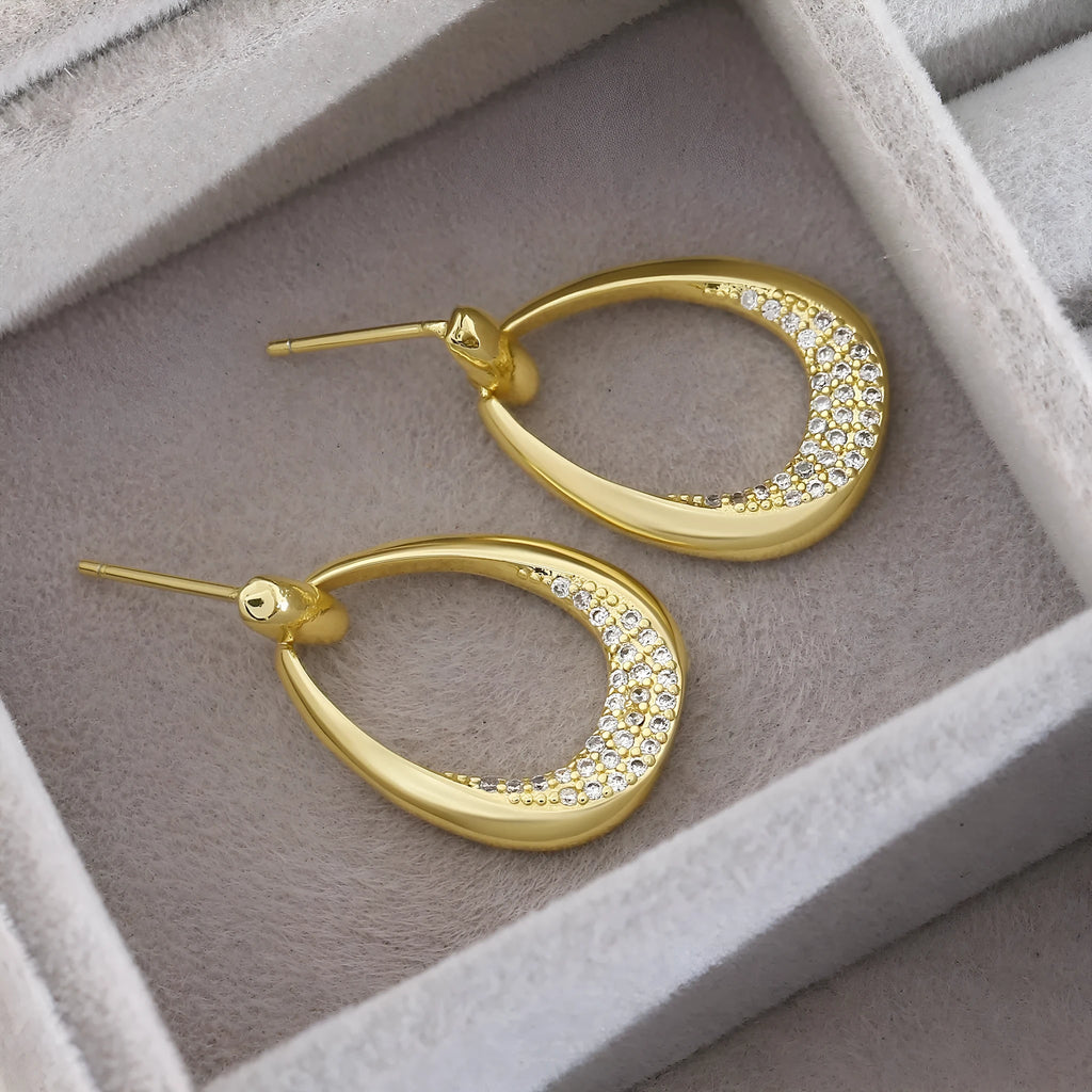 Women's yellow gold geometric drop earrings with oval rings measuring 2.6cm