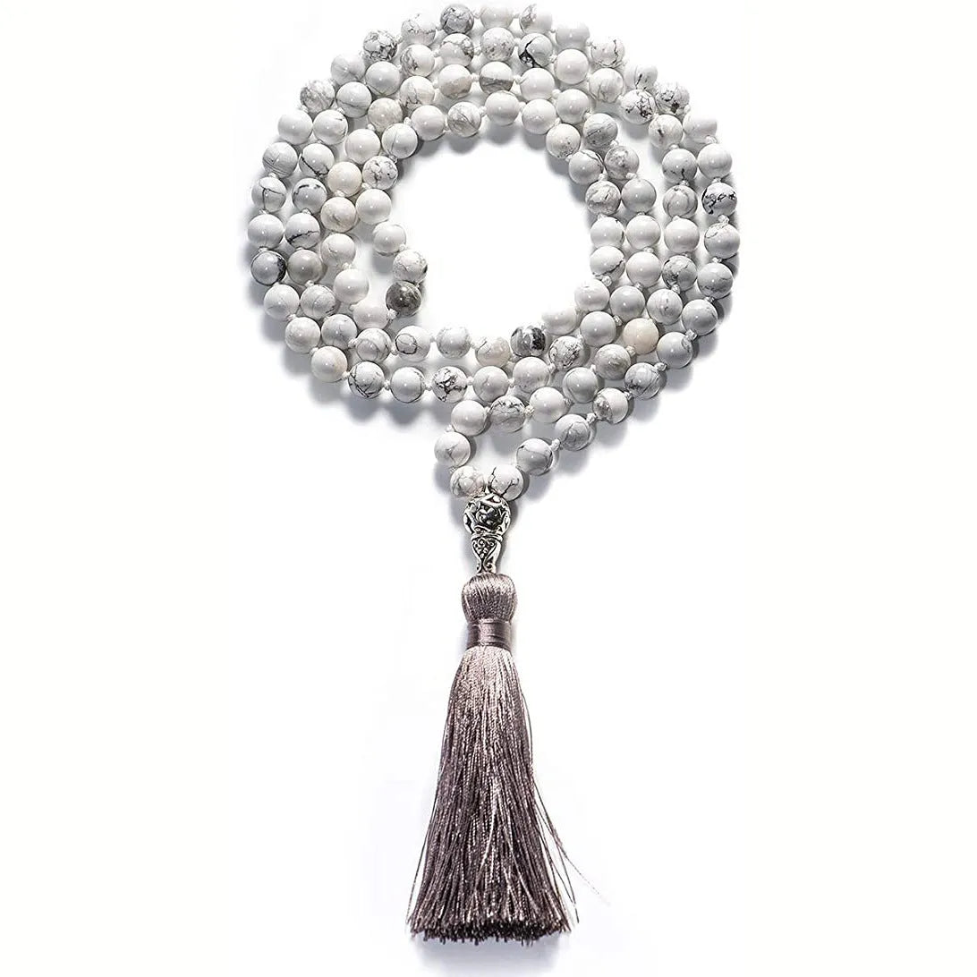 Long beaded agate and amethyst tassel necklace with blue grain stone and lapis lazuli on a geometric design.