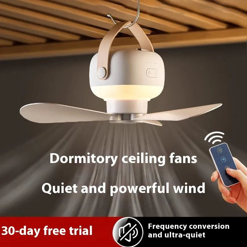 Small rechargeable electric fan for camping tent with night light on, hanging from a strap