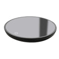 Black circular mug warmer with temperature switch, 12cm in diameter, on a desk next to a coffee cup.