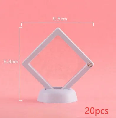 Transparent 3D floating display case holding a coin, with black and white size options