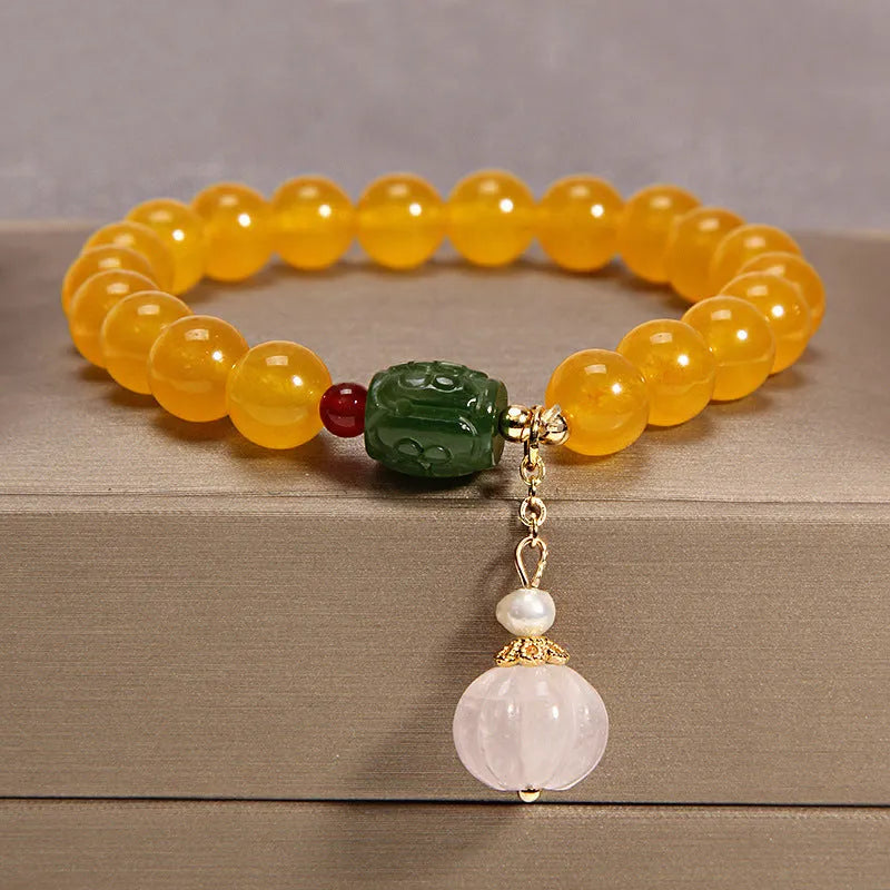 Yellow agate crystal bracelet with gold silk threading on wrist