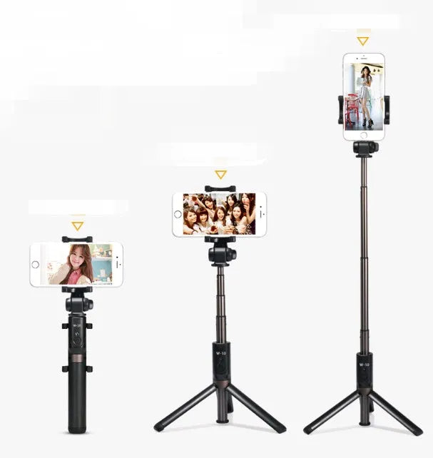 Black Bluetooth selfie stick tripod with remote control extended, holding a smartphone