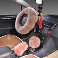 Wool steering wheel cover in black fitted on a car steering wheel, with matching handle cover visible
