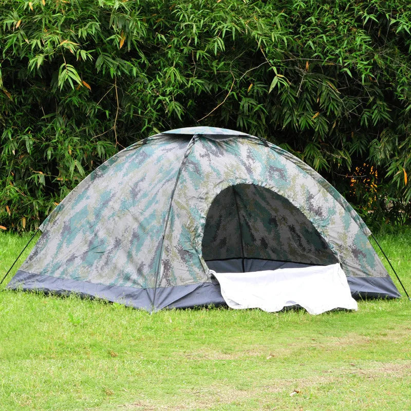 Green camouflage two-person dome tent with mesh panels and guylines pitched outdoors.