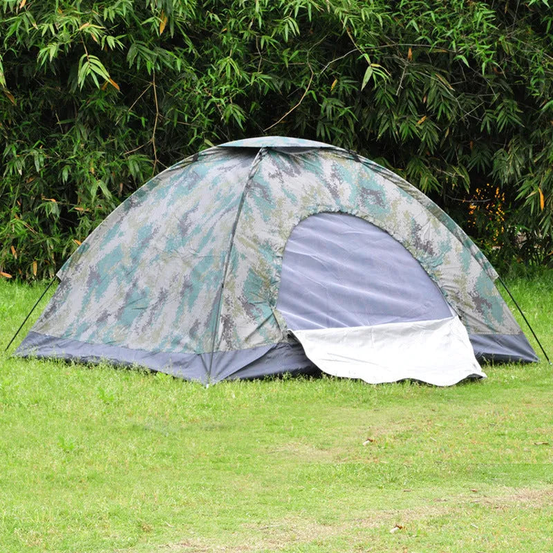 Green camouflage two-person dome tent with mesh panels and guylines pitched outdoors.
