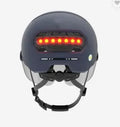 Blue adult cycling helmet with integrated LED front light and red tail light on the back