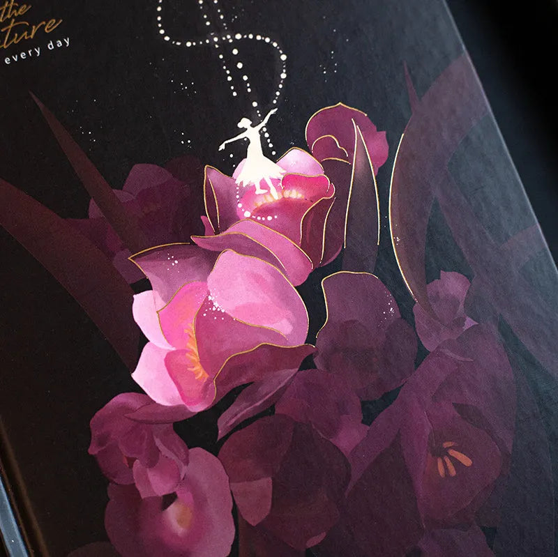 A5 notebook with luminous cover open to show pages with colour illustrations