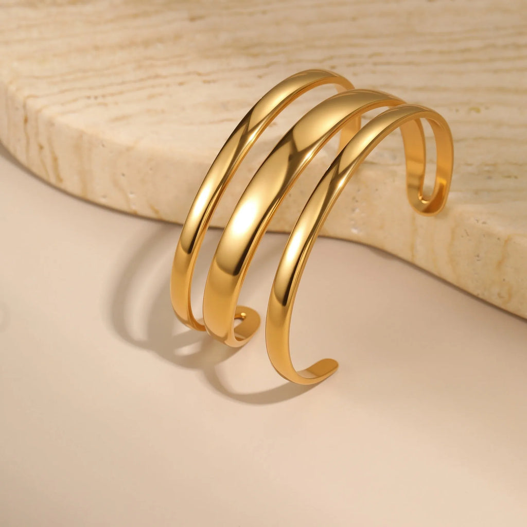 Stainless steel opening bracelet for women in gold or steel finish with geometric line design