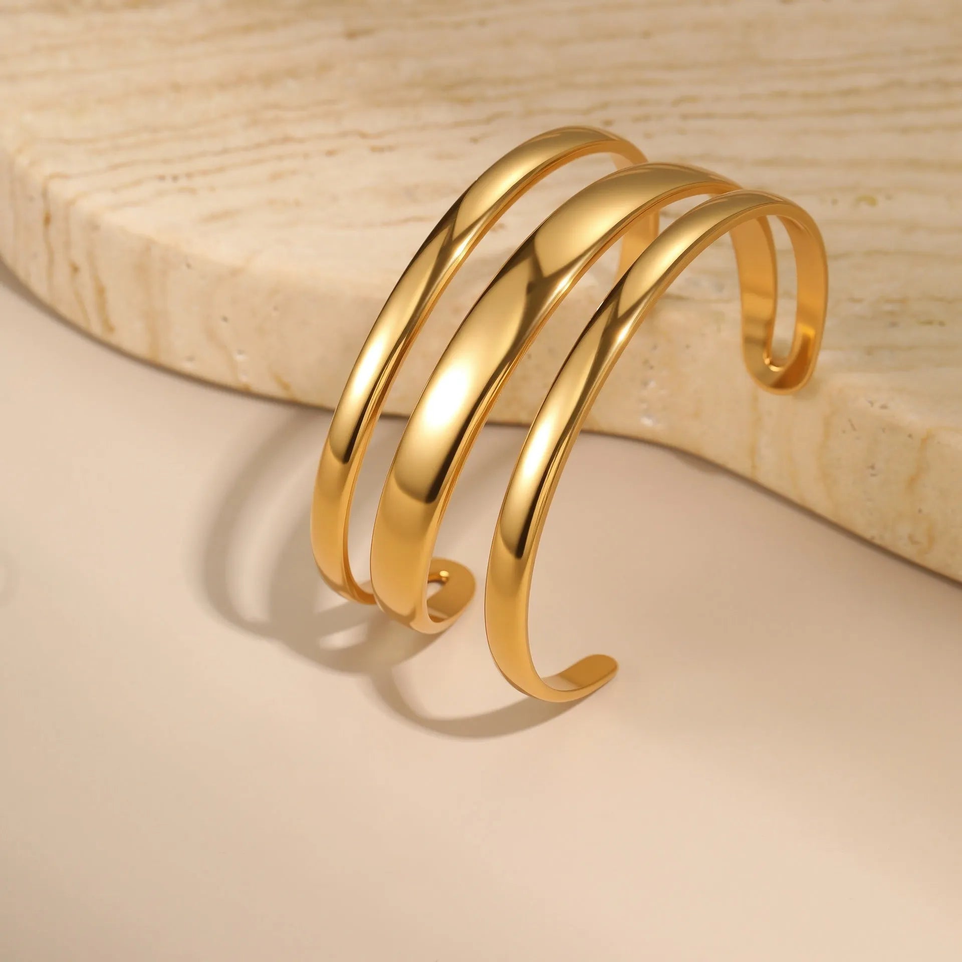 Stainless steel opening bracelet for women in gold or steel finish with geometric line design