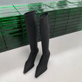 Black pointed toe women's below knee stiletto boots with a back zipper closure.