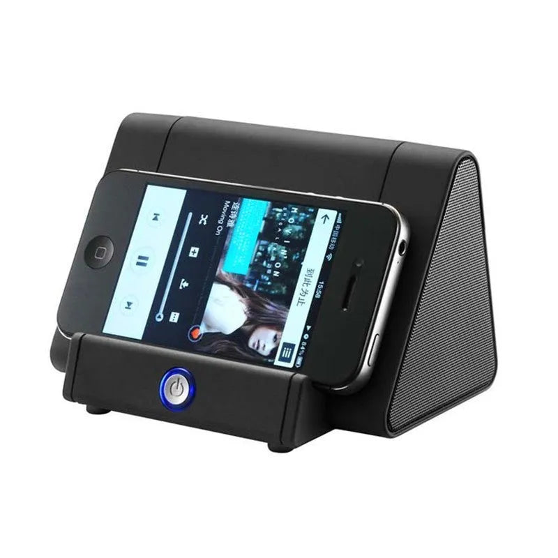 Compact black and white wireless mini Bluetooth speaker with built-in charging cable.