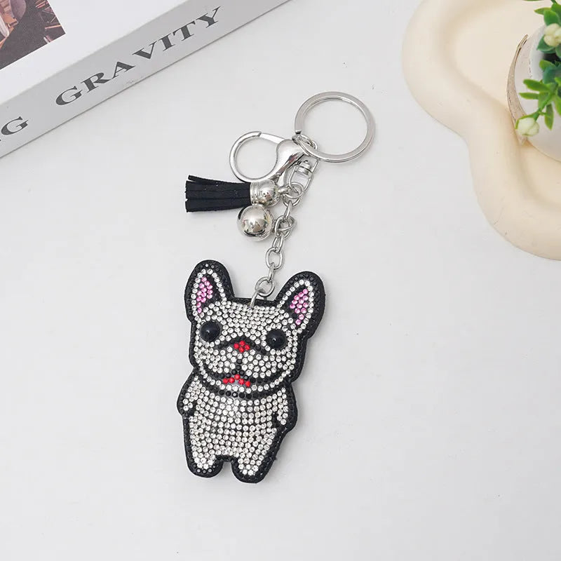 Close-up of a sparkling rhinestone French dog animal keychain charm in caramel colour.
