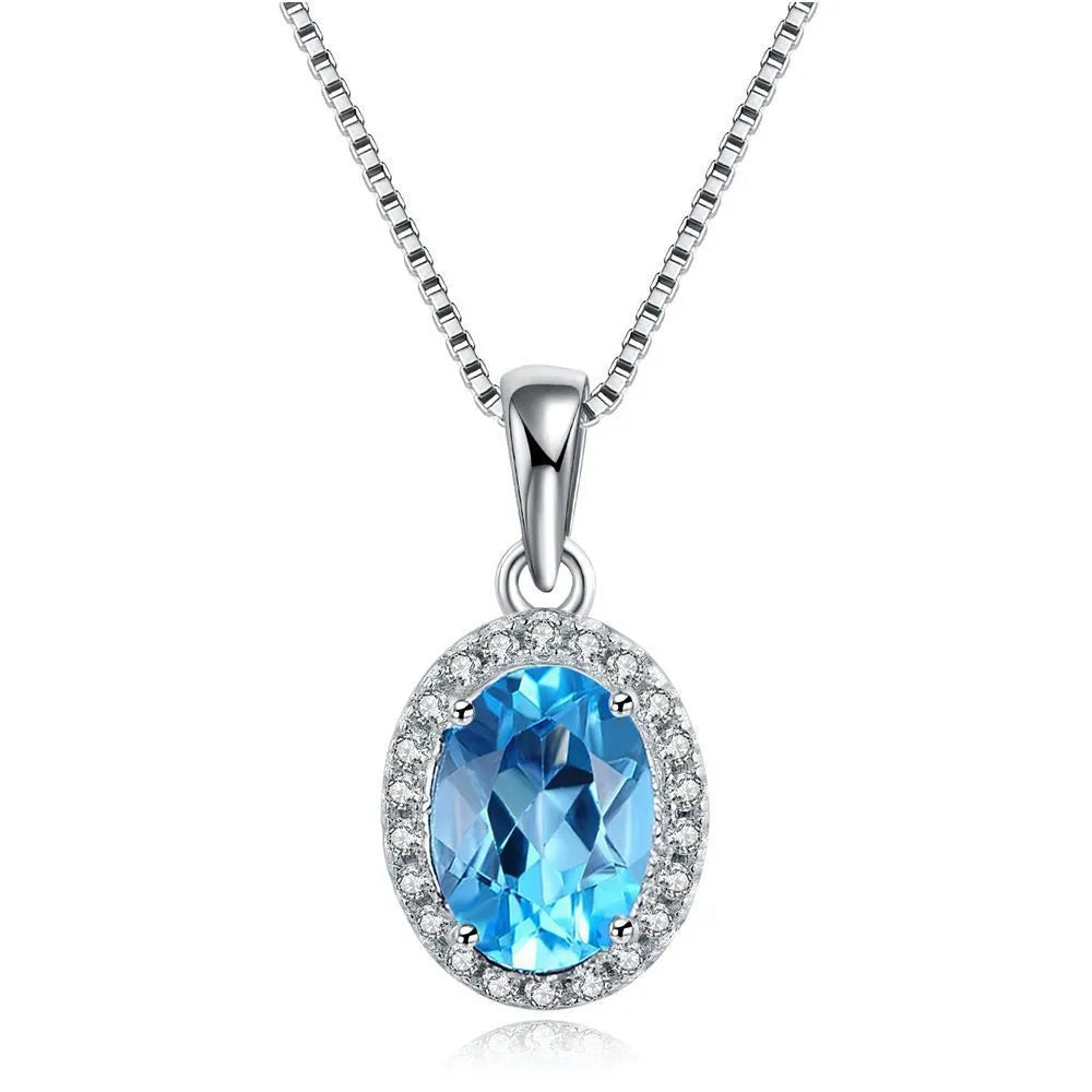 925 sterling silver jewellery set with blue topaz gems including geometric pendant necklace, earrings, ring, and bracelet.