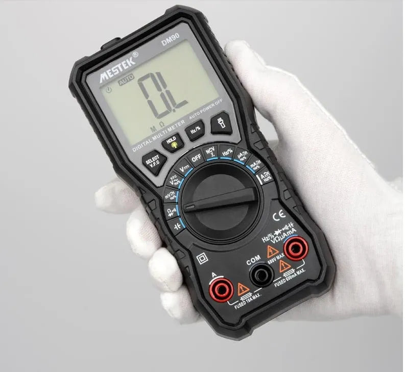 DM90A digital multimeter with display showing readings, test leads, and thermocouple probe on a workbench.