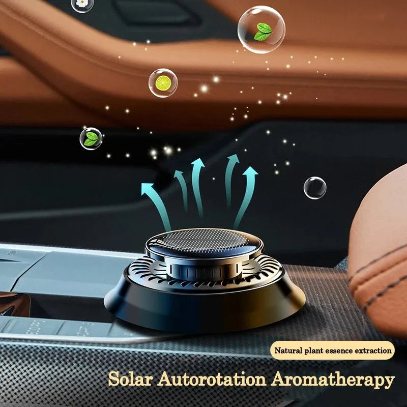 Solar-powered kinetic car air freshener with rotating black double rings on a dashboard