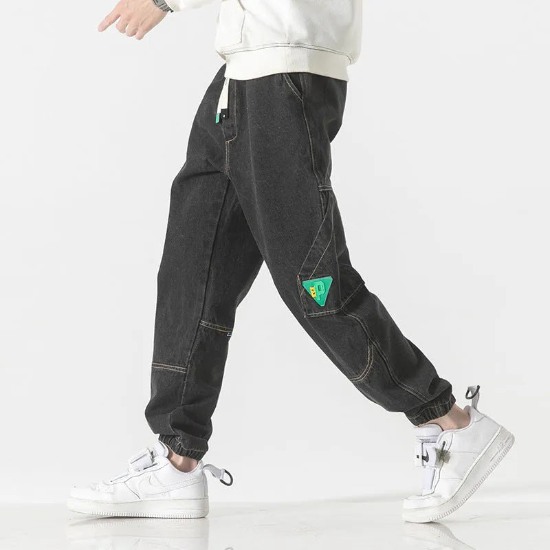Men's cotton loose-fit tapered trousers in black colour showing mid-waist design and tapered leg silhouette