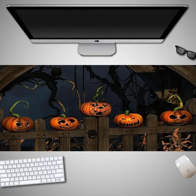 Halloween-themed oversized mouse pad with non-slip rubber cloth backing on a desk