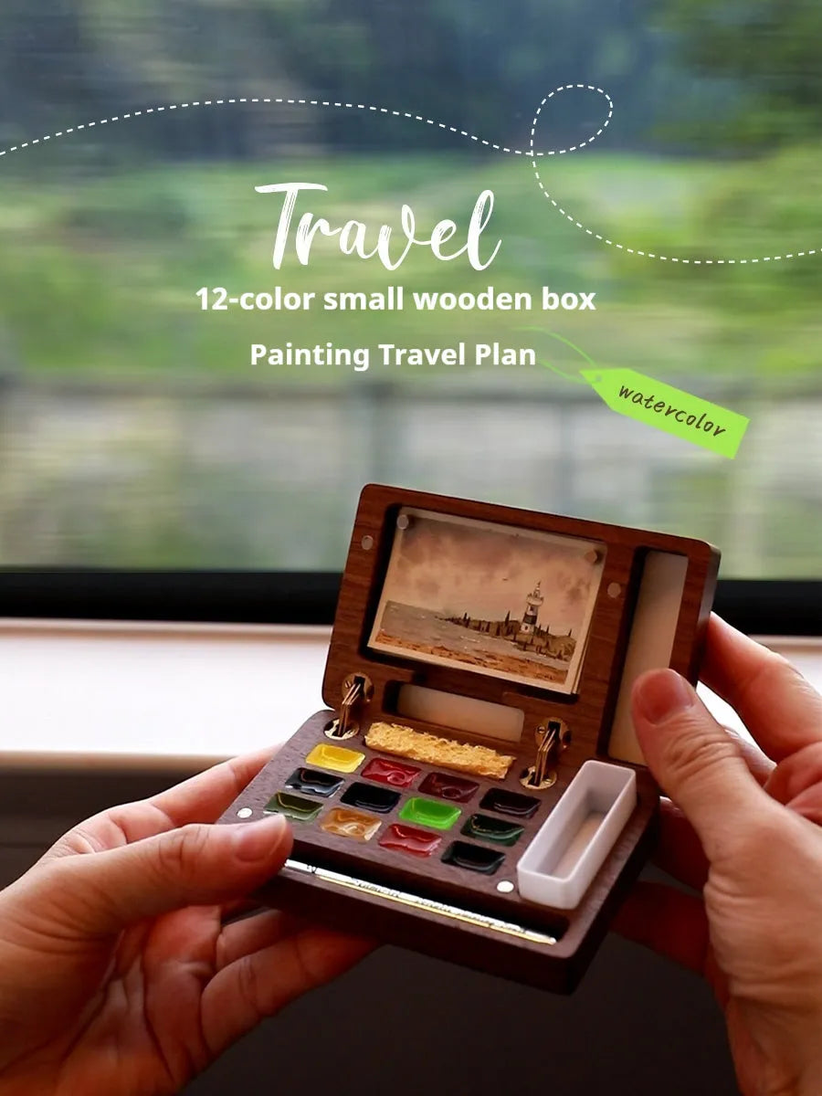 Miniature walnut wood watercolour paint box open to show 24 half-pan pigments and mixing areas