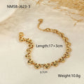 Hollowed-out stainless steel heart bracelet in gold finish on a wrist.
