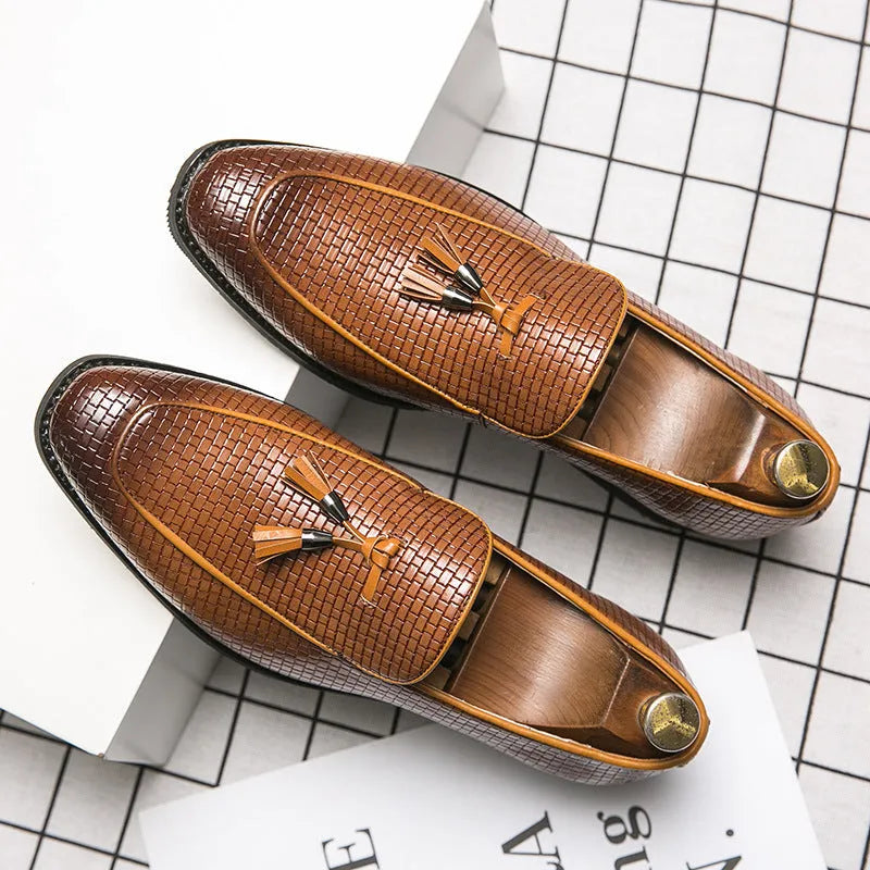 Men's black pointed toe slip on loafers with a tassel detail on the front.