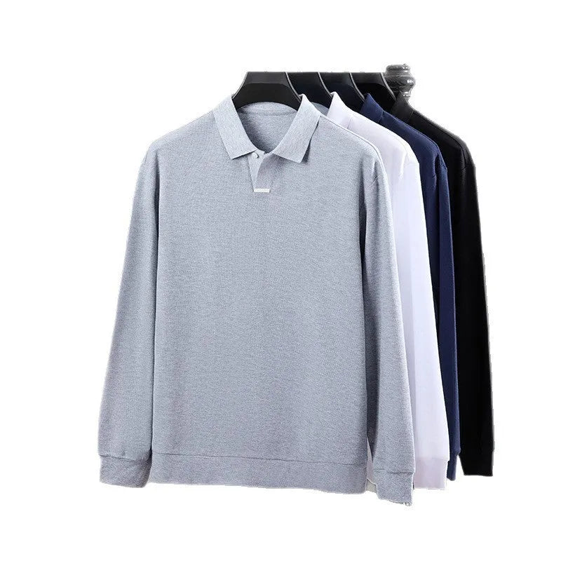 Man wearing a grey loose fit cotton polo shirt with a lapel collar and long sleeves.