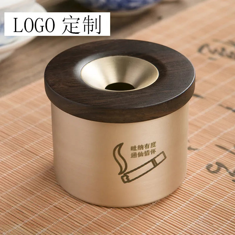 Retro brass and copper ashtray with wooden lid on a living room table.