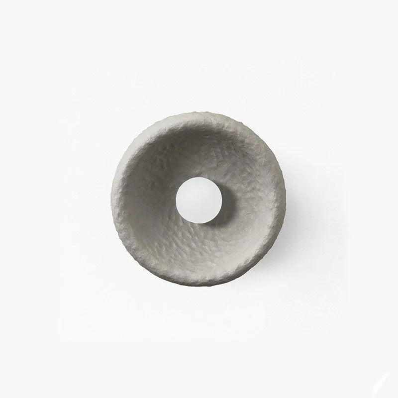 Japanese-style minimalist wall lamp with resin shade in three diameter sizes on white wall
