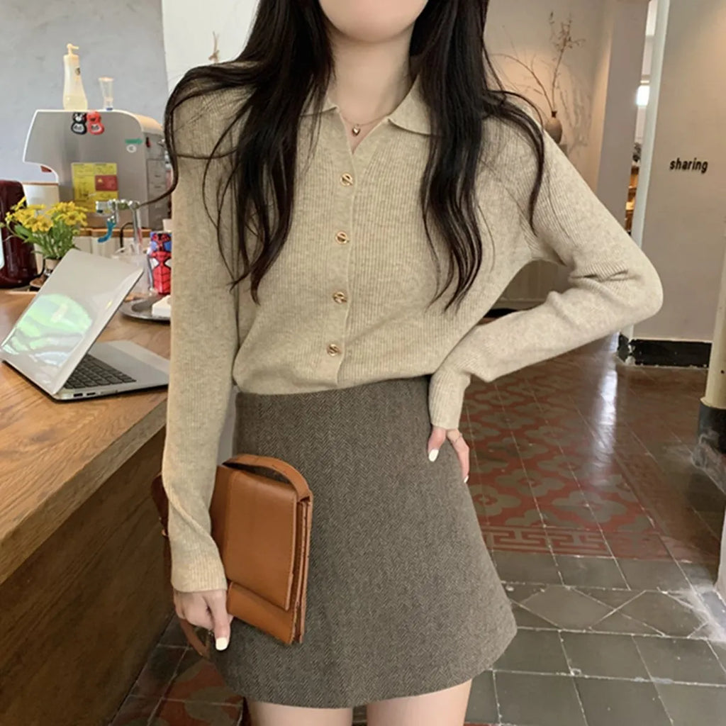 A loose-fitting, long-sleeved beige knitted cardigan for women, made from viscose fibre.