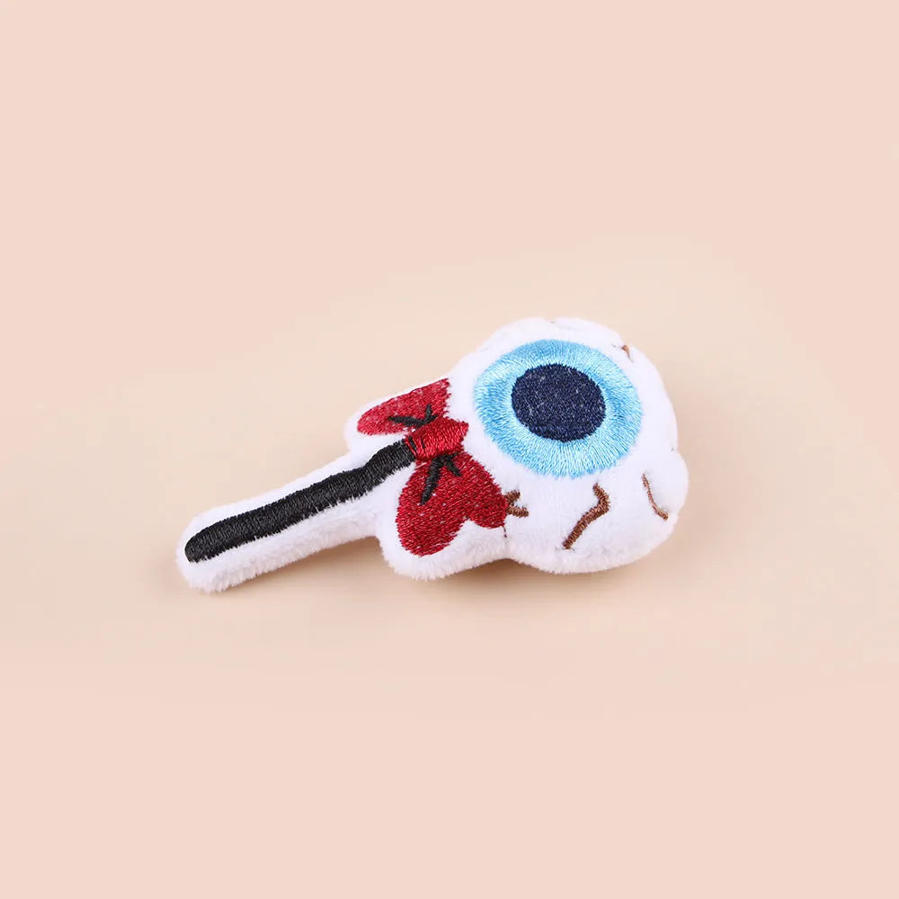 Plush cat teaser toy with long wand handle showing candy and skull designs