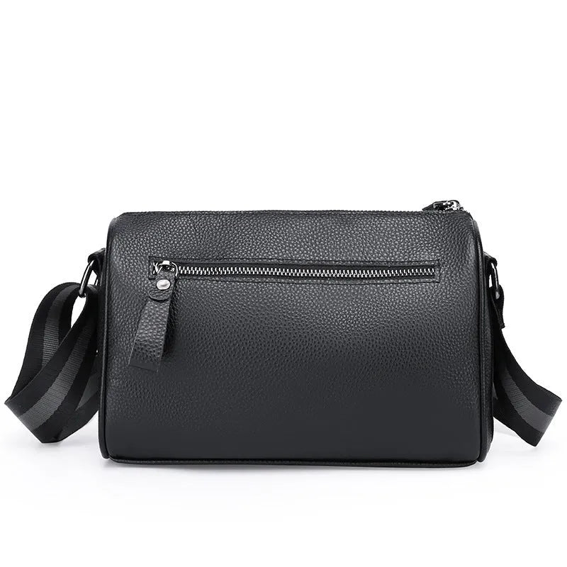 Black genuine leather crossbody bag with one shoulder strap showing interior polyester lining