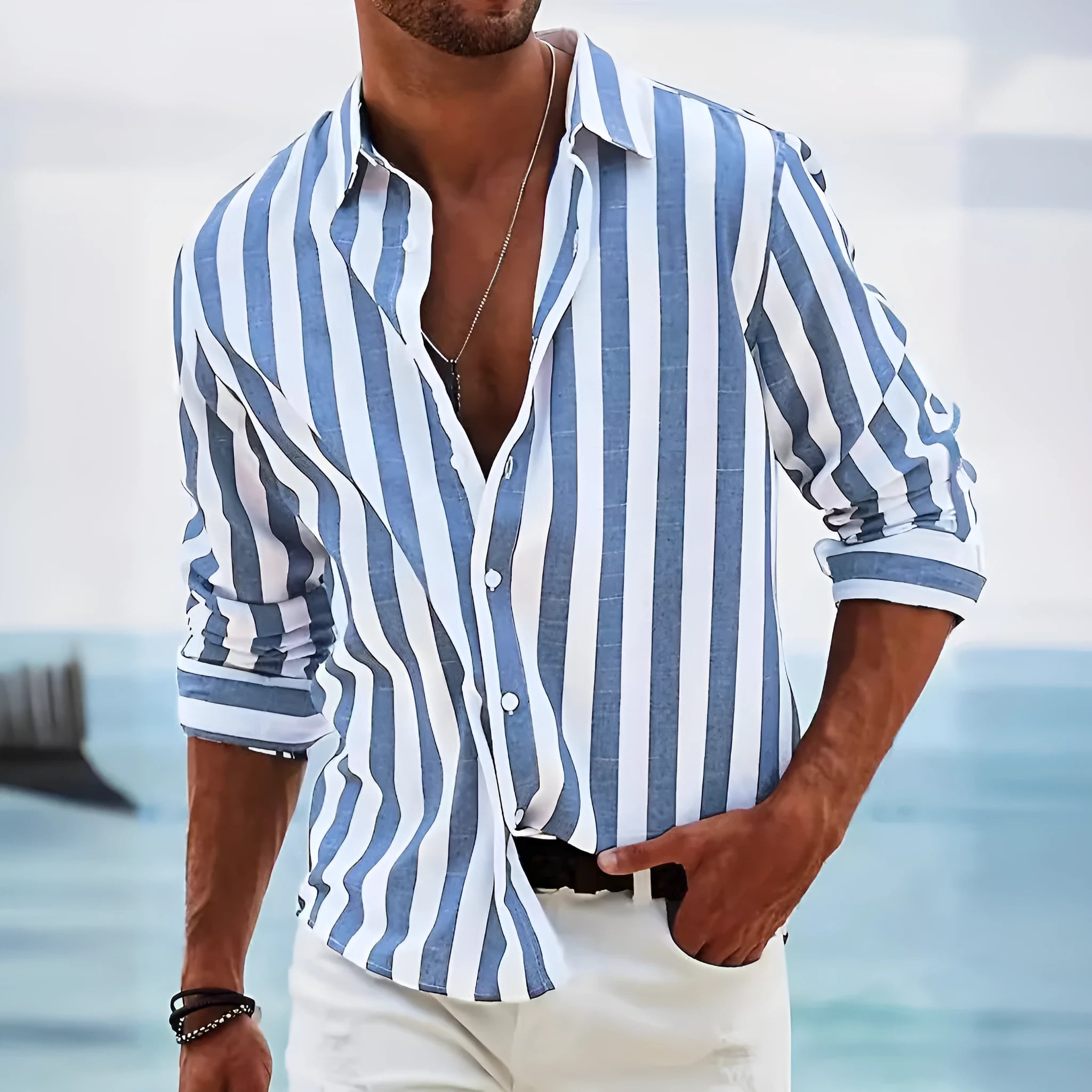 Man wearing a light grey and black striped loose-fit long sleeve casual shirt, British cardigan style.