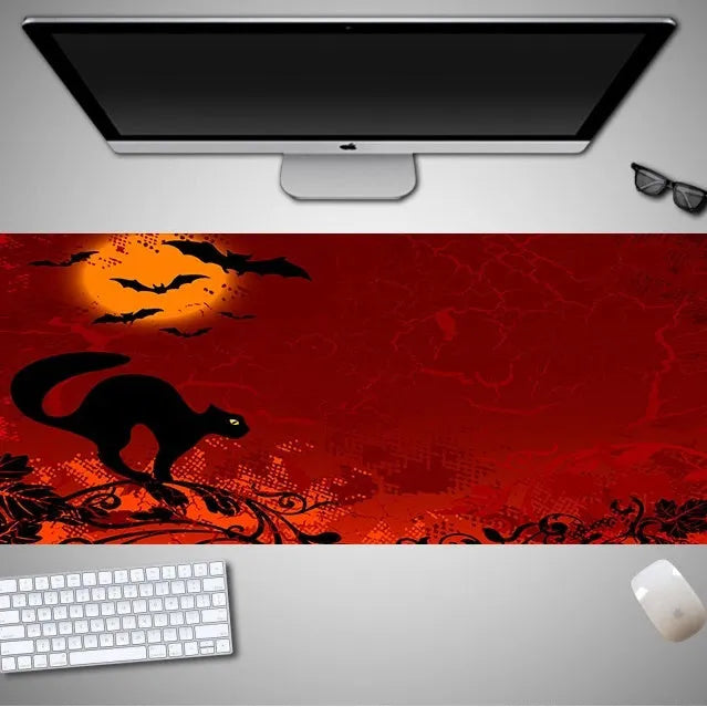 Halloween-themed oversized mouse pad with non-slip rubber cloth backing on a desk