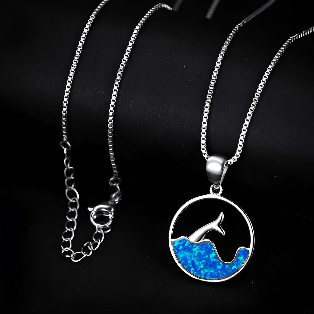 Close-up of a women's electroplated copper necklace with a geometric fishtail tail pendant in a blue opal colour.
