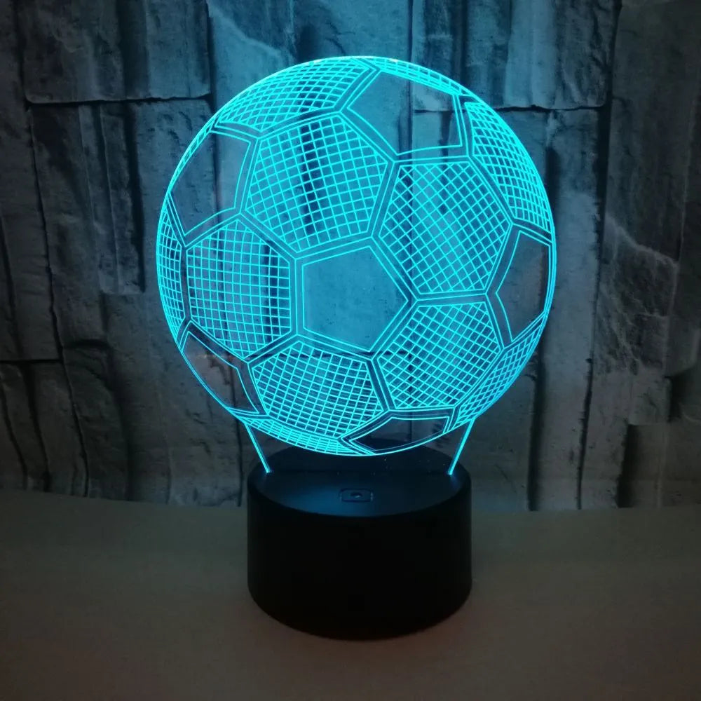 3D acrylic football night light on a square black base, showing multi-coloured LED illumination.