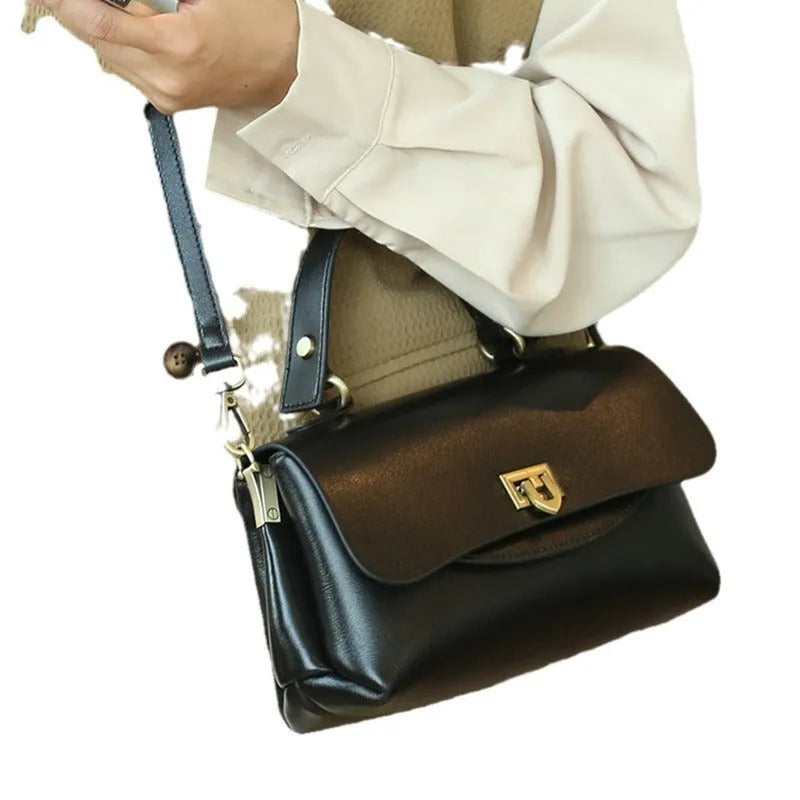 Women's retro genuine leather saddle handbag in black with visible stitching and double shoulder straps