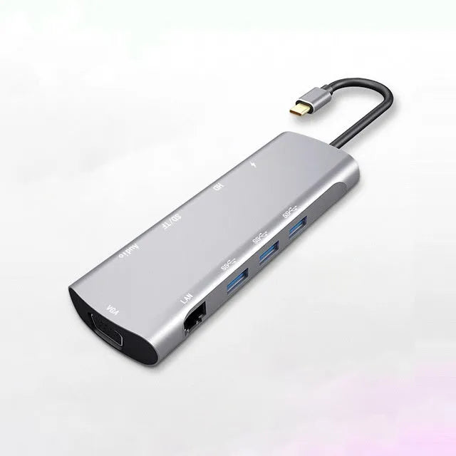 Grey USB-C docking station with aluminium alloy shell showing HDMI, VGA and USB ports
