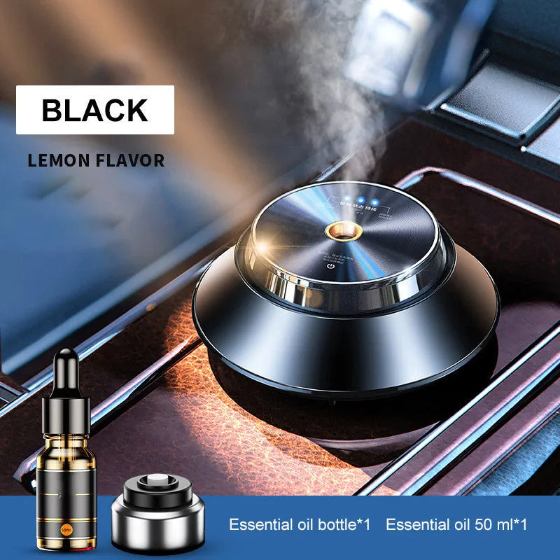 Black butterfly-shaped metal car aromatherapy diffuser with USB cable and bottle of essential oil.