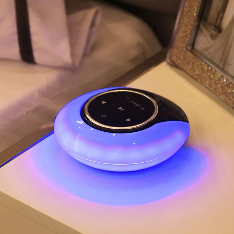 Blue Bluetooth desk lamp with speaker, shown folded, with touch controls on a white base.