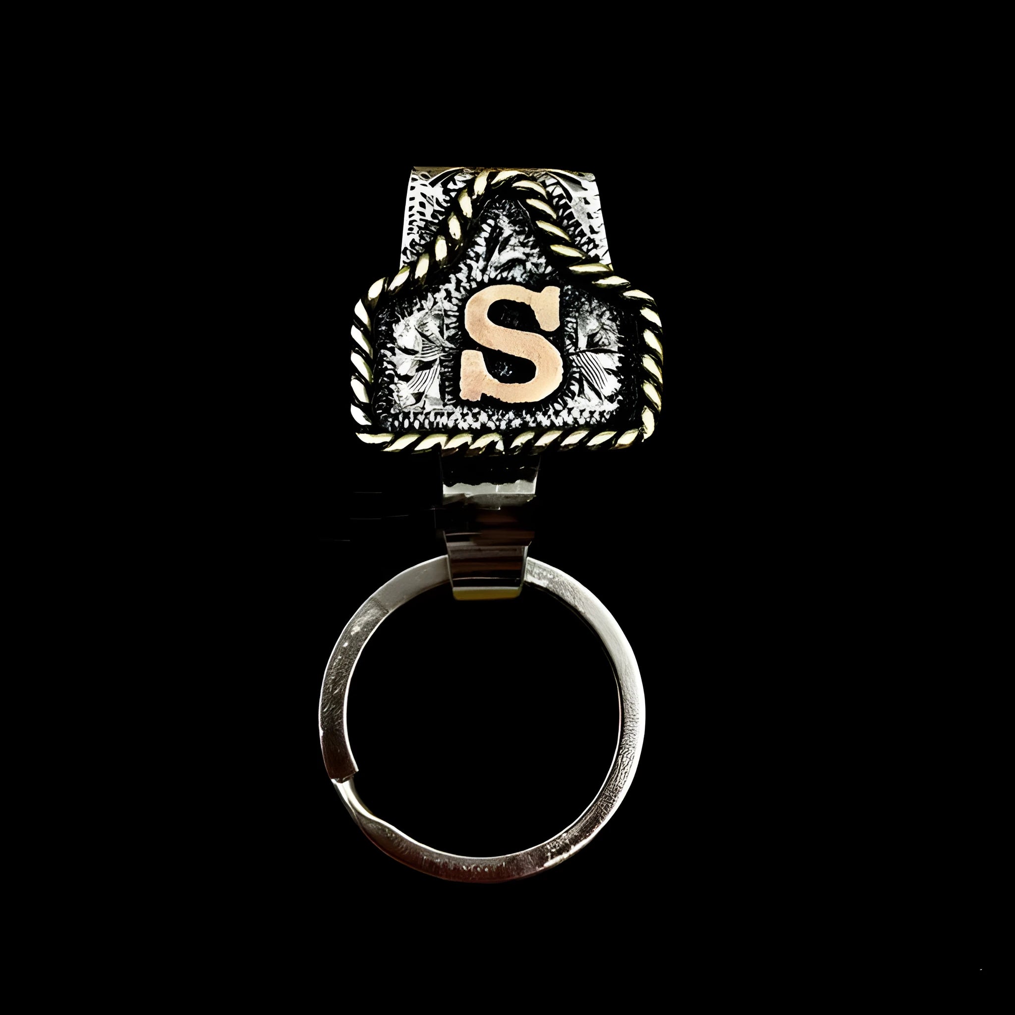 Handmade metal keychain with a cow motif, shown in one of 26 available colours.